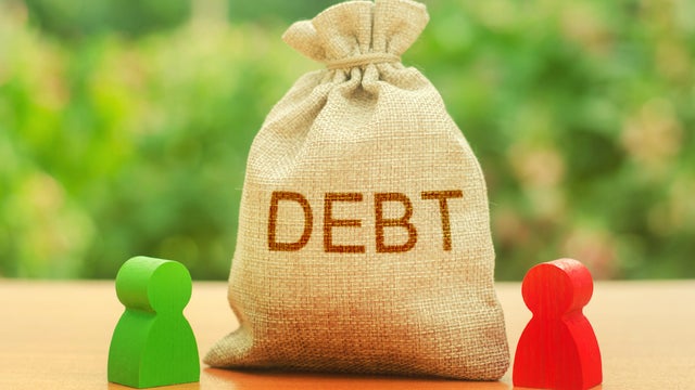 A bag with the inscription DEBT stands between two figures of people. Unclosed obligations between two persons, financial or moral debt. refusal to return debts. redemption and restructuring 