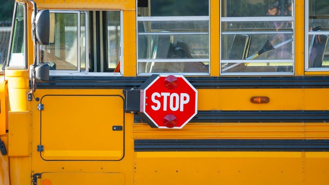 Close up on school bus with stop sign 