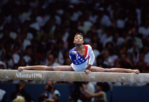 Dominique Dawes during a balance beam routine at the 1996 Olympics in Atlanta, her leotard has an American flag design