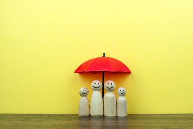 Wood Figurine with Smiling Face Under Red Umbrella 