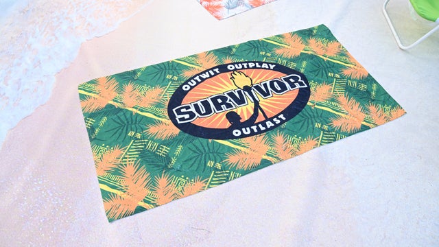 A beach towel prop with the SURVIVOR logo 