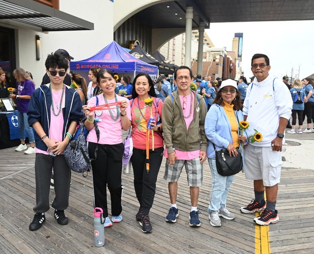 People post for photos at the Out of the Darkness Walk on benefiting the American Foundation for Suicide Prevention