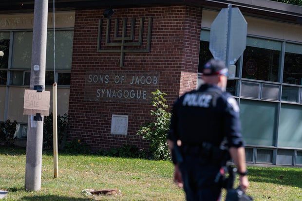 Scene from outside the Sons of Jacob Synagogue where a man armed with a shotgun exchanged gun fire with a police officer stationed outside of the Synagogue late Sunday evening as people were arriving for Yom Kippur. 