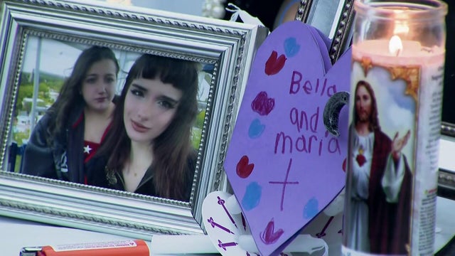 Framed photo of Maria Niotis and Isabella Salas and a prayer candle 