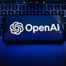 In this photo illustration, an OpenAI logo is seen displayed 