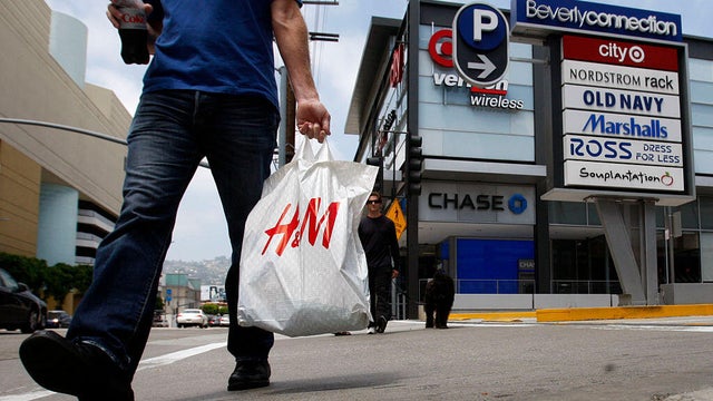 A shopper walks on La Cienega Blvd next to the Beverly Connection in Los Angeles on June 6, 2013. 