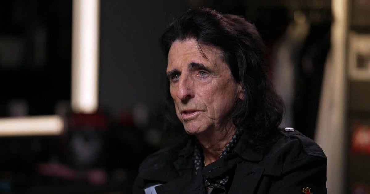 Alice Cooper warms up for his outrageous on-stage antics by throwing knives