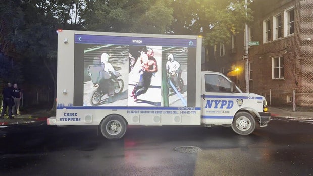 NYPD van with photos of suspects