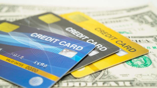Credit card model on US dollar banknotes, finance and business. 