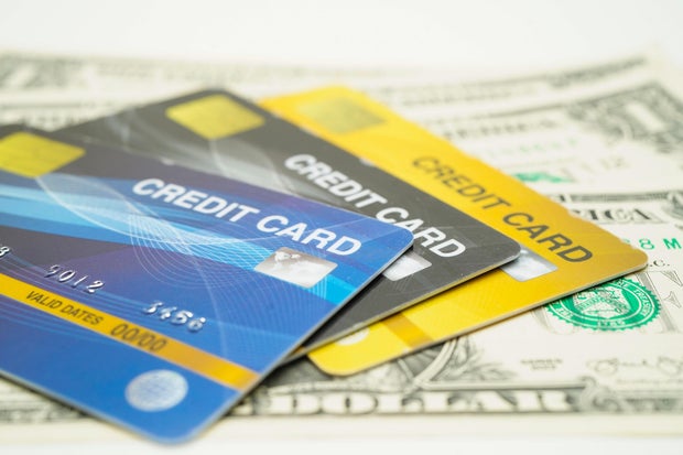 Credit card model on US dollar banknotes, finance and business.
