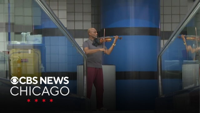 Violinist Samuel Williams plays for travelers passing through O'Hare
