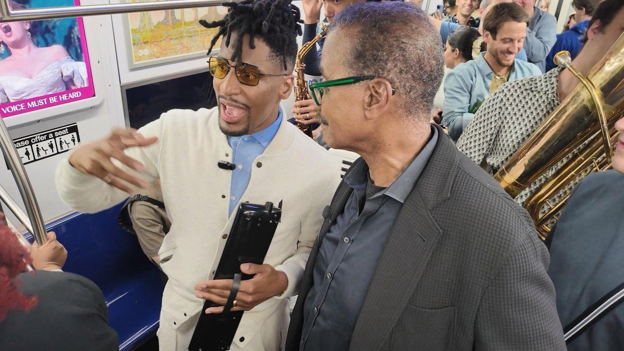 Jon Batiste and Bill Whitaker during a "love riot" 