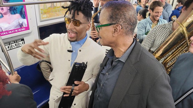 Jon Batiste and Bill Whitaker during a "love riot"