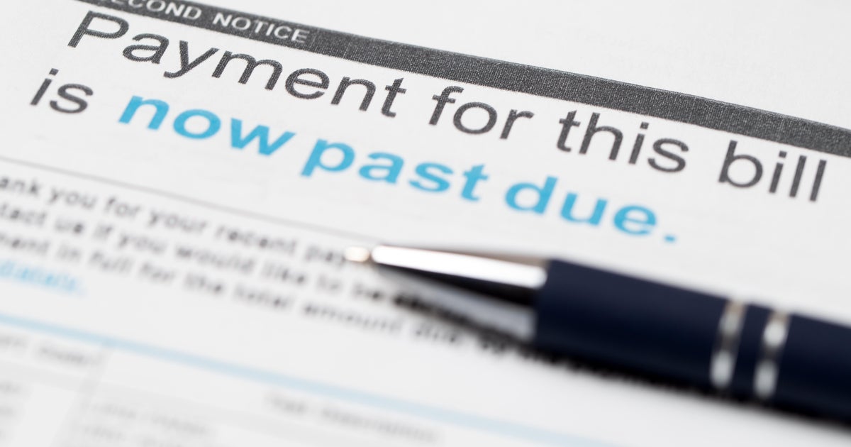 Squeezed by inflation, more Americans are falling behind on their debts