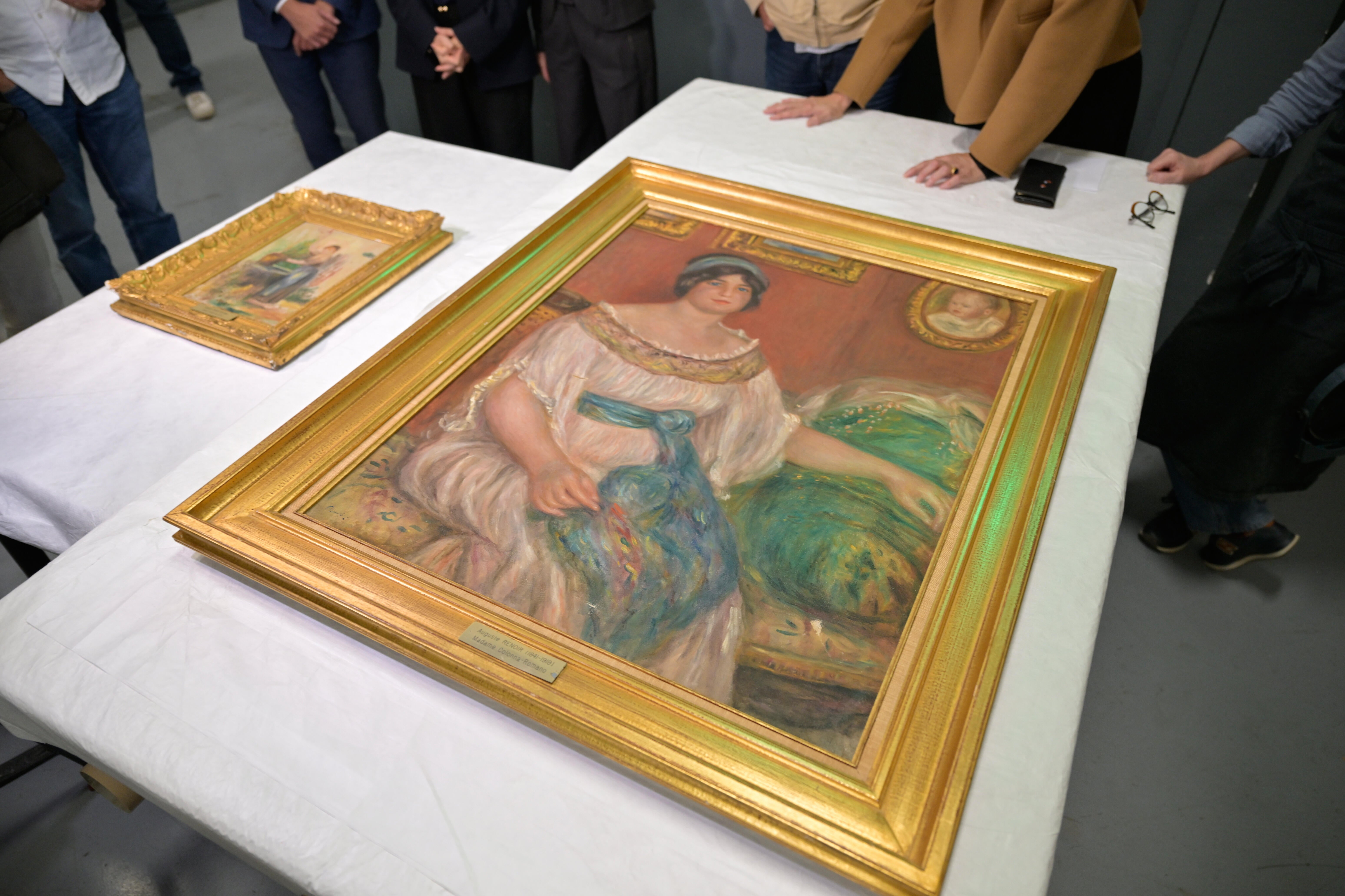 Stolen Renoir paintings found hidden behind cinder block wall