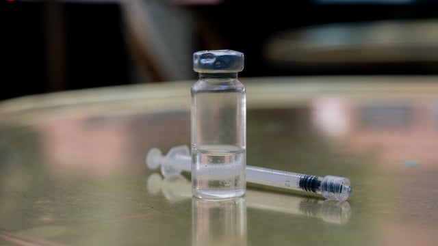 Small vial of the drug retatrutide with a syringe 