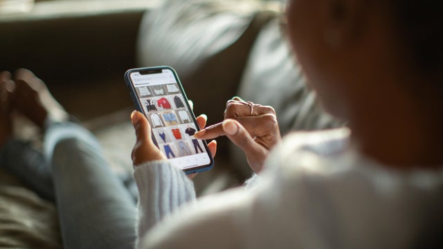 Woman purchasing clothes on a mobile app 