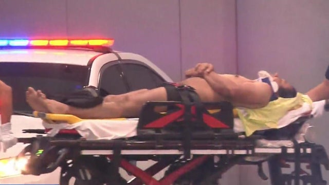 Surveillance video shows a man pushing a scooter struck by a hit-and-run driver in Miami