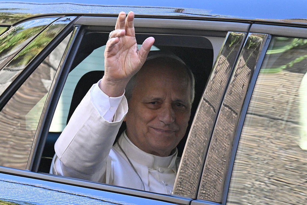 Pope Leo XIV waves from car window 