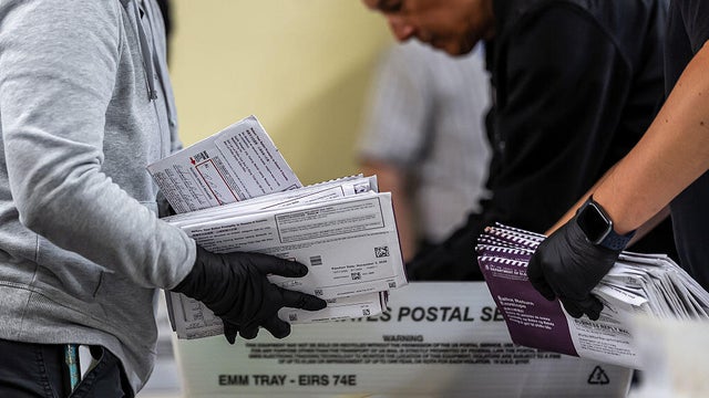 Election workers sort through ballots during early voting at City Hall in San Francisco, California, on Oct. 8, 2026. 