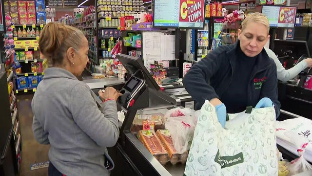 A shopper paying for groceries at a CTown supermarket in New York City 