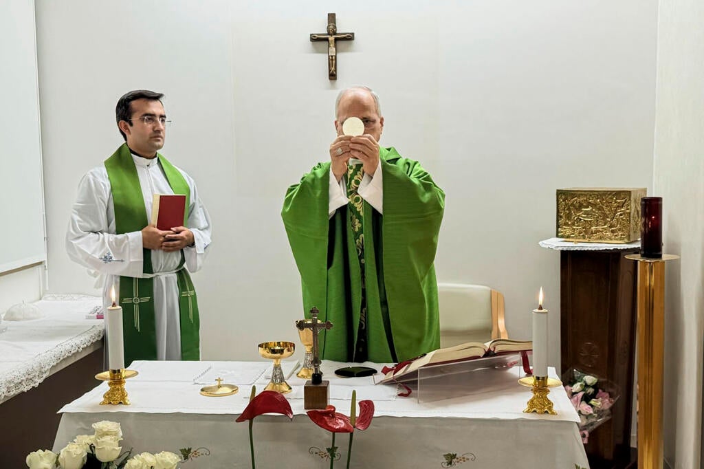 Pope Leo XIV, flanked by his personal secretary, Monsignor Edgard Iván Rimaycuna Inga, celebrates Mass at the Agostino Gemelli Polyclinic in Rome. Vatican Media via AP