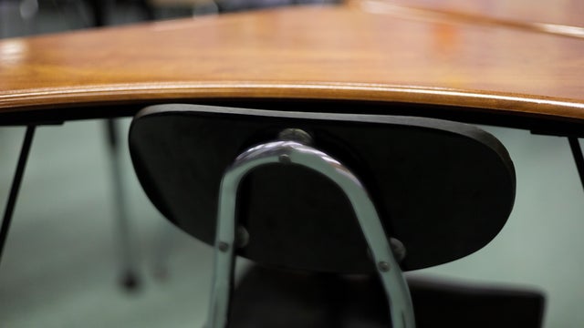Close-up of a chair on a student's desk inside a classroom in a secondary school. 