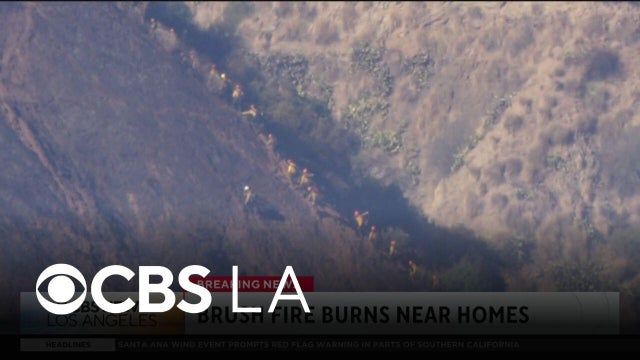Azusa brush fire burns dangerously close to homes