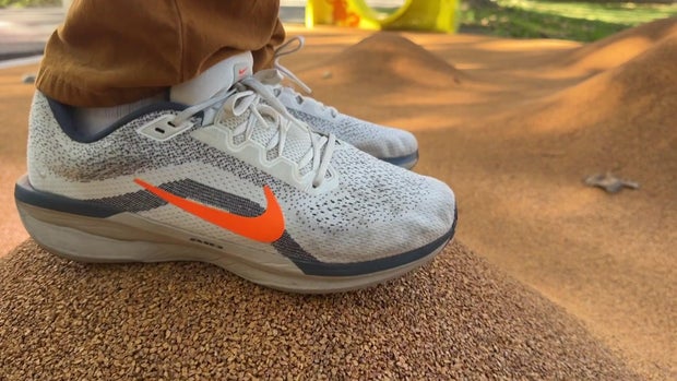 Close-up of feet on a poured-cork playground surface