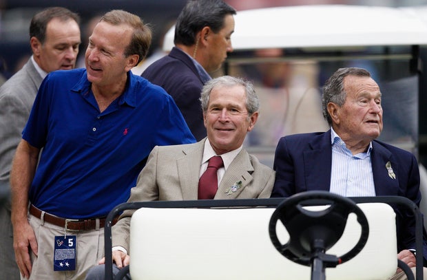 Neil Bush and Presidents George W. Bush and George H.W. Bush at Reliant Stadium on Nov. 17, 2013, in Houston, Texas.