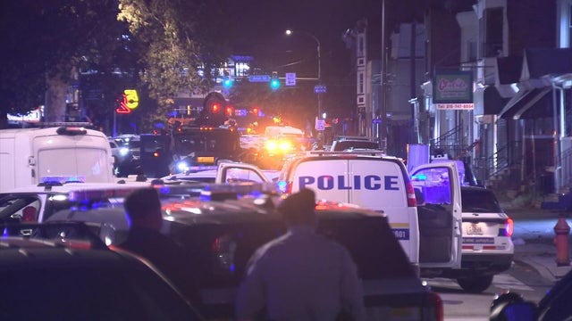 Police vehicles fill the street after two police officers were shot in West Philadelphia 