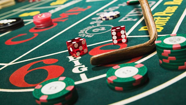 Croupier stick clearing craps table 