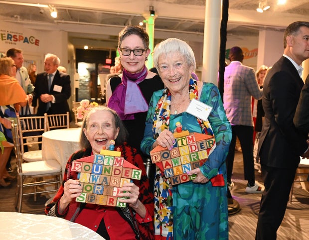 People pose for photos at a gala at the Please Touch Museu,