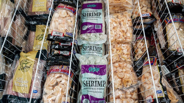 Seafood products, including uncooked and cooked shrimp, tilapia and other fish, are displayed in the frozen food aisle at a Presidente Supermarket in North Bay Village, Florida. 
