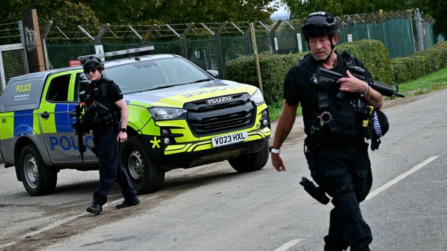 UK charges 2 men in alleged air base plot