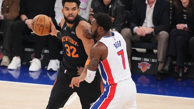 New York Knicks' Karl-Anthony Towns (32) protects the ball from Detroit Pistons' Paul Reed (7) during the first half of an NBA basketball game Tuesday, Oct. 27, 2026, in New York. 