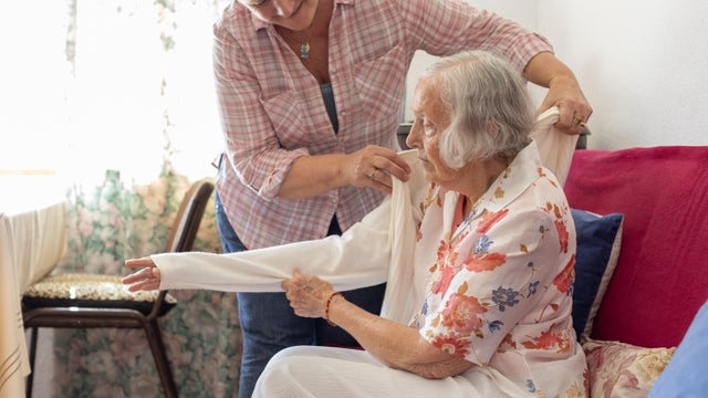 Mature woman caring for her elderly mother 