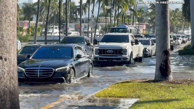 Cars struggle to get through amid flooding