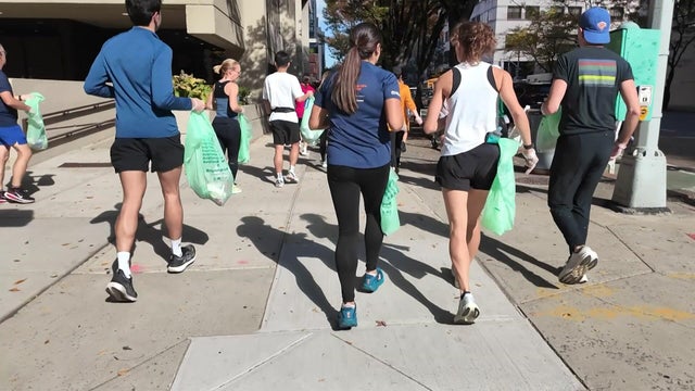Volunteers with compostable bags jog 