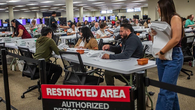 Workers prepare ballots to be scanned for counting at the Orange County Registrar of Voters facility in Santa Ana, California, on Oct. 28, 2026. 