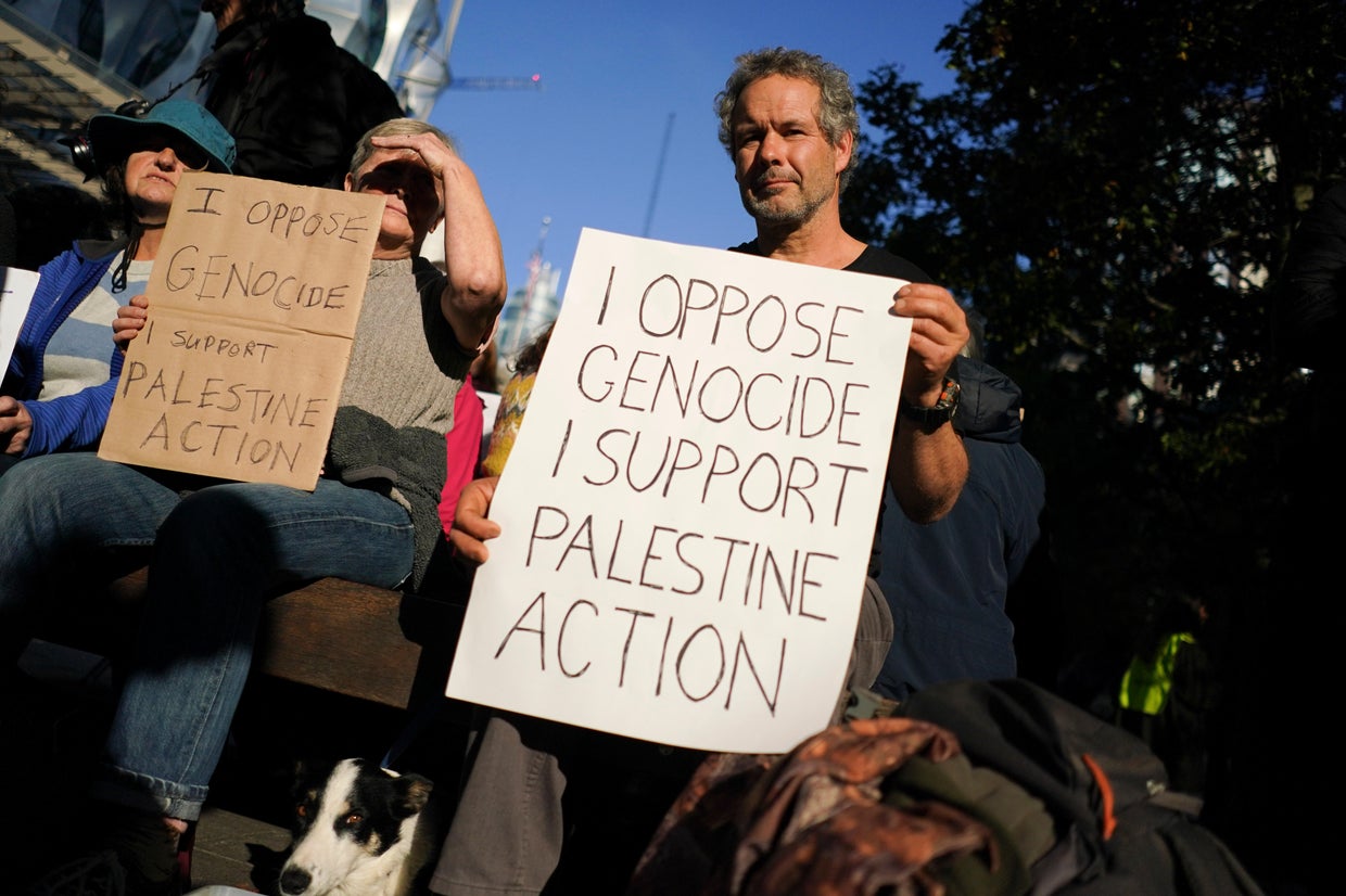 A protester holds a placard during a demonstration in support of Palestine Action, outside the U.S. Embassy, in London, Saturday, Oct. 31, 2026. Alberto Pezzali/AP